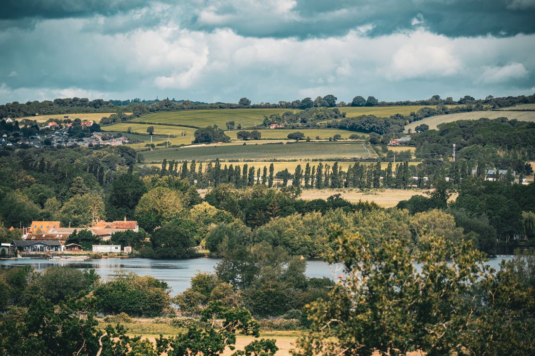 Quiet rolling countryside under a broad, considered sky