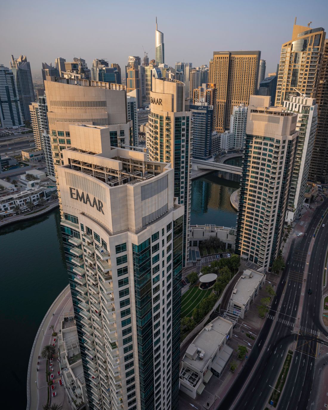 A modern Gulf financial skyline at sunset