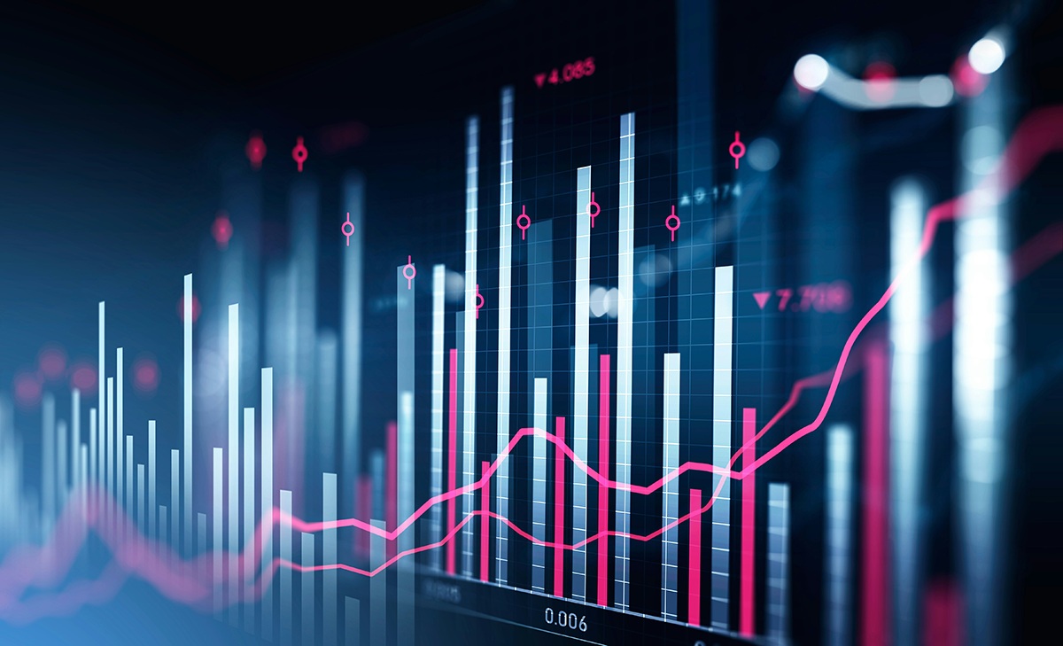 Trading desk with multiple screens of financial charts under independent review