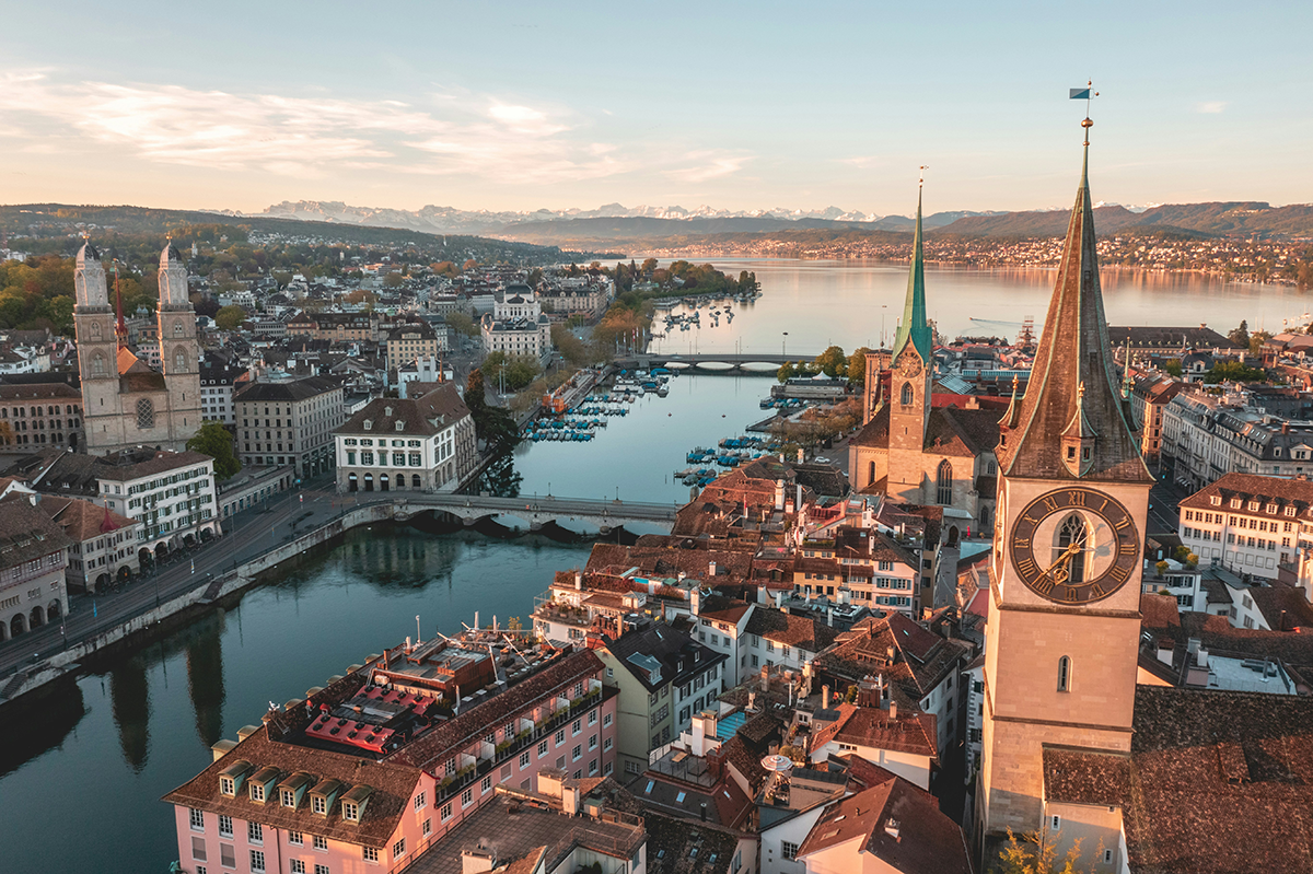Aerial view of Zurich's old town, river and lake at golden hour